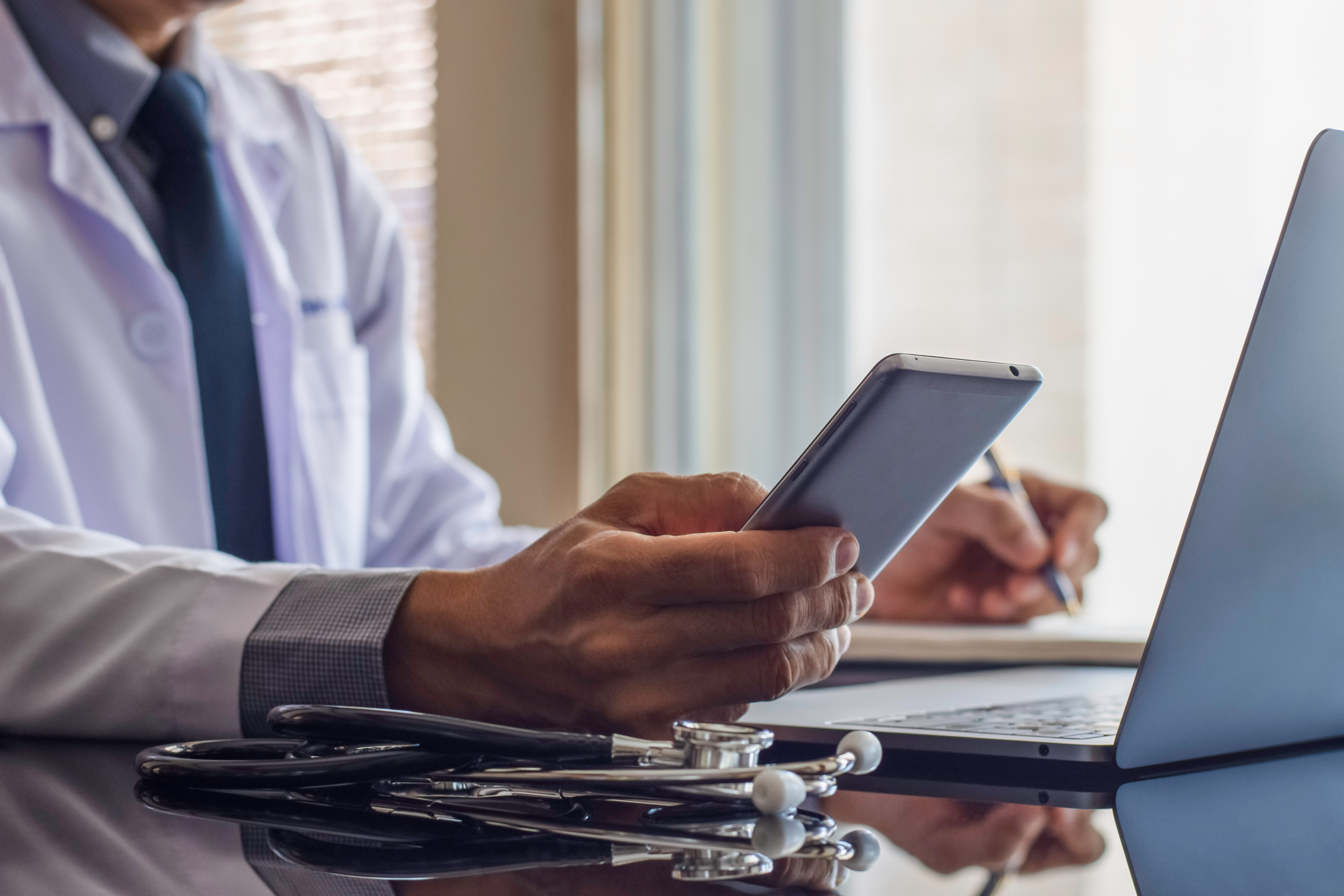 Doctor browsing his phone