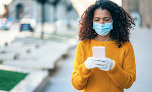 Woman on the street with mask and gloves