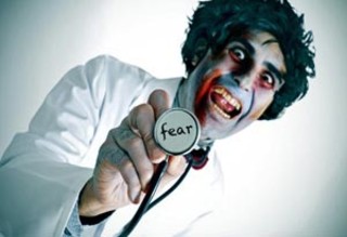 Person with clown-like makeup and wild hair wearing a lab coat, holding a stethoscope labeled 