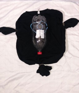 Placement of the 2-liter bottle in the center of the shirt