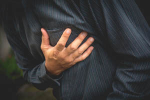 man holding his chest