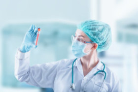 BBP-epidemiologist-wearing-ppe-and-gloves-holding-a-container-with-blood