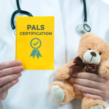 a PALS certified doctor is holding a certificate and a child’s teddy bear