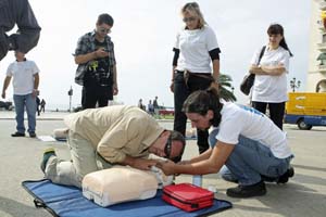 group doing CPR on victim on ground