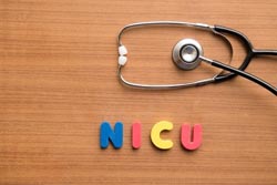 NICU Colorful Letters with stethoscope on wood background