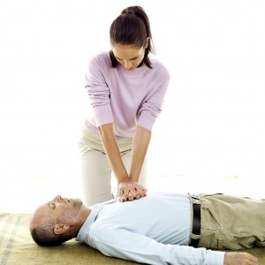 woman giving man CPR