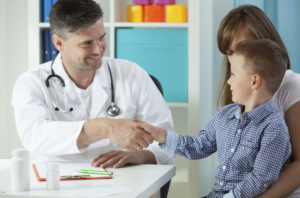 pediatric shaking childs hand with parent