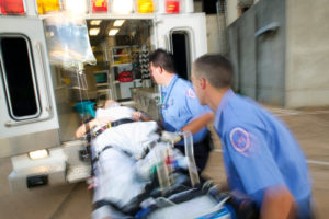 emt-pushing-wheeled-stretcher-in-an-ambulace