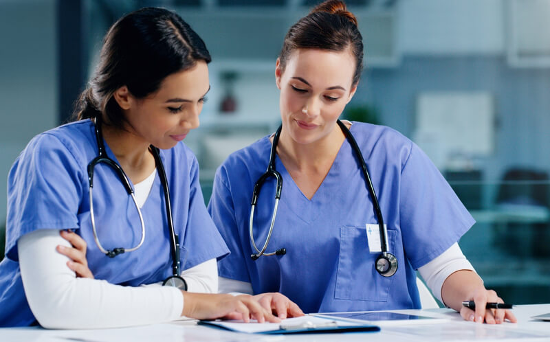 two-healthcare-professionals-reading-algorithms