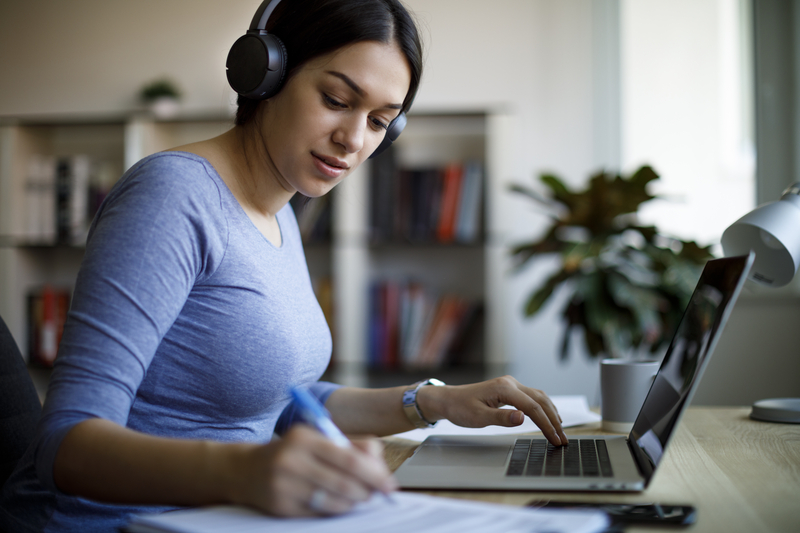 woman-studying-an-online-course-using-a-laptop-and-a-headset