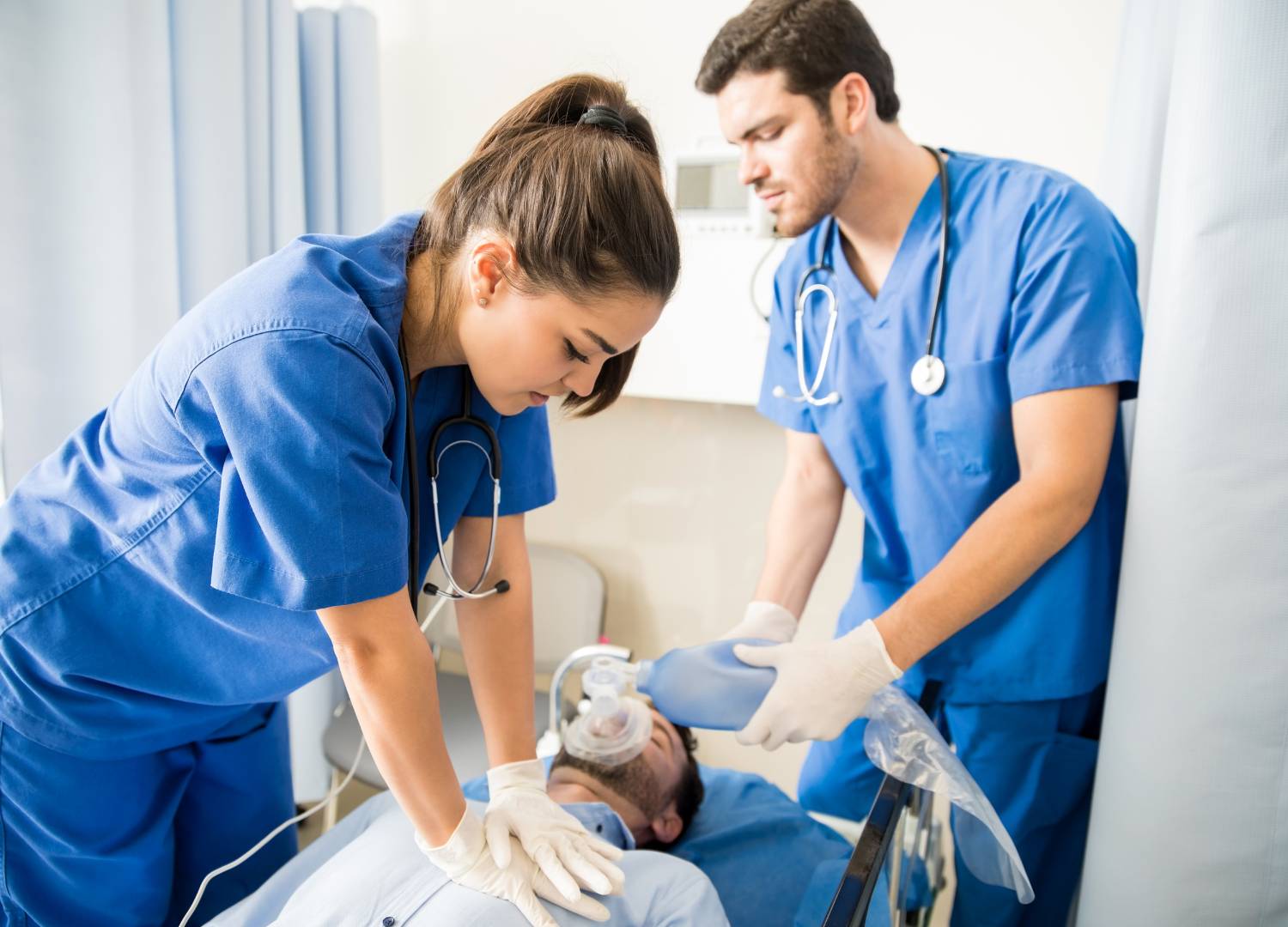 Medical professionals performing CPR and providing ventilation support to a patient experiencing respiratory arrest. 