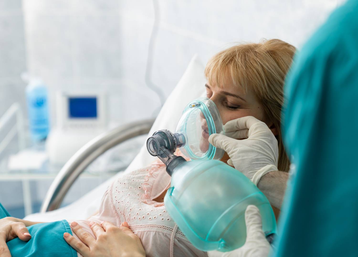 Healthcare provider using a manual resuscitator to provide ventilation support to a patient in respiratory arrest. 