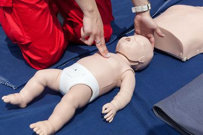 CPR training on an infant mannequin