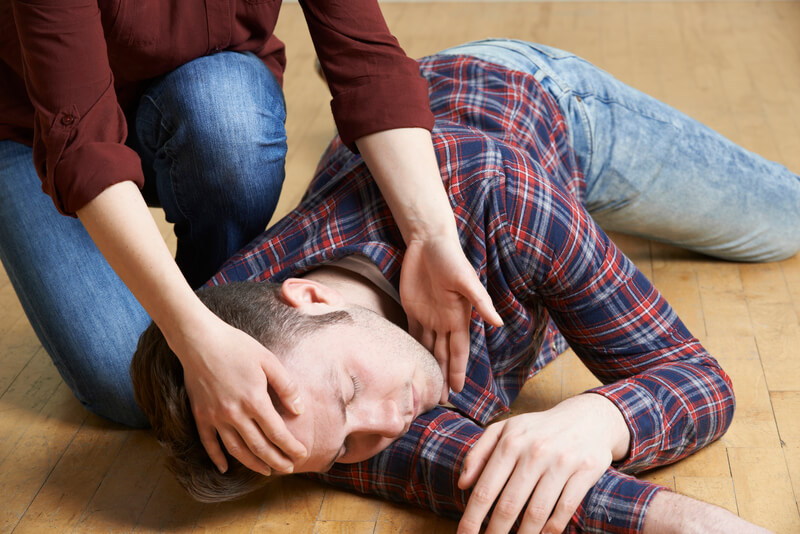 an unconscious man lying on the floor