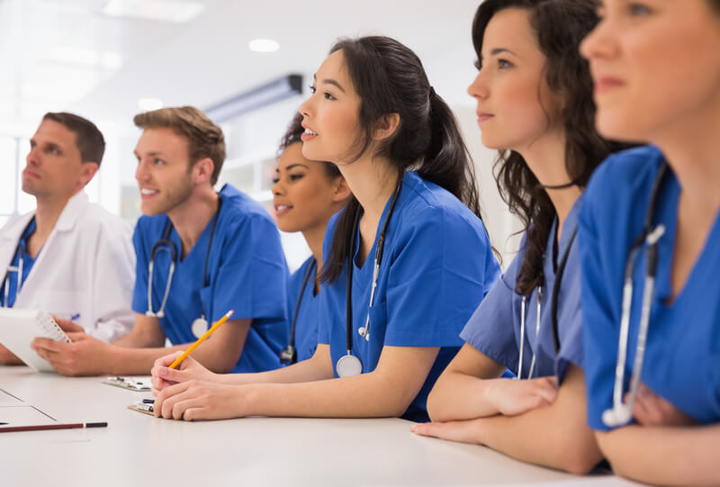 A group_medica staff and healthcare professionals is in a class learning bls courses